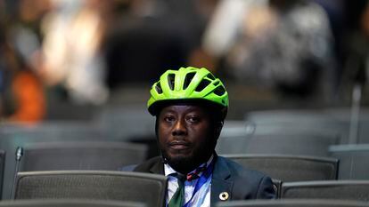 Ivorian activist Andy Costa, wearing his helmet and tie, on Monday at the opening of COP27 in Sharm el Sheikh.