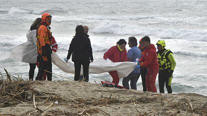 Italian firefighters and Red Cross personnel gather at the scene where bodies of migrants washed ashore following a shipwreck, at a beach near Cutro, Crotone province, southern Italy, 26 February 2023.