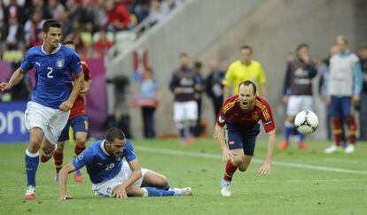 Andr&eacute;s Iniesta (right) feels the force of a tackle by Italy defender Leonardo Bonucci in Gdansk. 