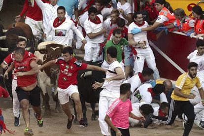 A pile of runners on the ground as the animals enter the Pamplona bullring.