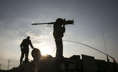 An Israeli soldier holds a weapon near the Gaza Strip.
