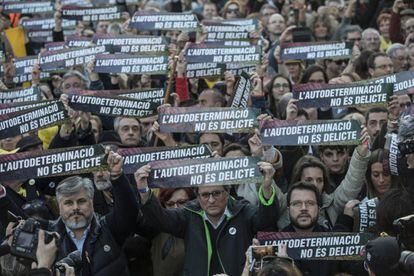 Protesters hold signs with the message: “Self-determination is not a crime.”