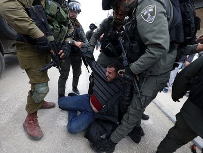 Israeli soldiers detain a Palestinian man during a protest to mark the 'Land Day' in Huwara village, near the West Bank city of Nablus, on March 31, 2023.