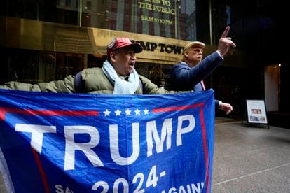 A supporter of former President Donald Trump, and a man impersonating the former president stand outside of Trump Tower on Friday, March 31, 2023