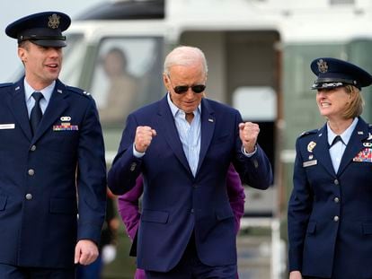 President Joe Biden walks with Capt. Eric Anderson, deputy director of flightline protocol for the 89th Airlift Wing, and Col. Angela Ochoa, commander of the 89th Airlift Wing, right, before leaving Andrews Air Force Base, Md., Friday, March 8, 2024, to travel to Philadelphia for a campaign event.