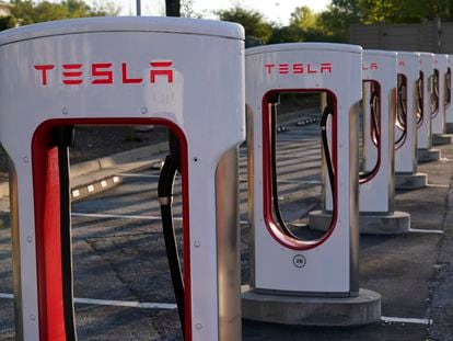 FILE - In this April 22, 2021, photo shows a Tesla Supercharger station in Buford, Ga. Tesla reports earnings on Wednesday, Jan. 25, 2023.
