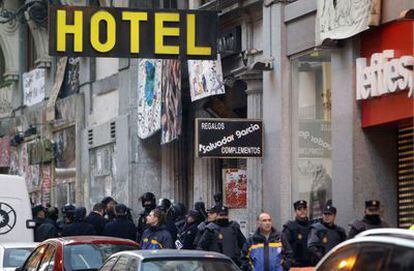 Police officers in riot gear outside the Hotel Madrid on Monday morning.