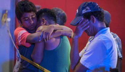 Tears and hugs after a shooting that left 23 people dead in a bar in Veracruz, Mexico last August.