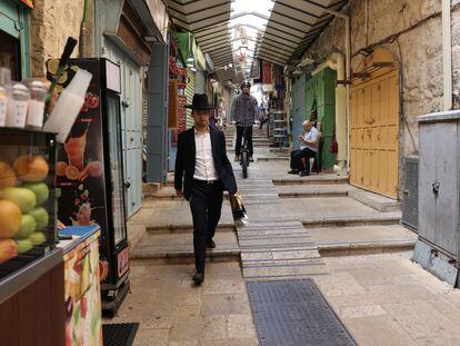 An ultra-Orthodox Jew walks through the Old City of Jerusalem, where several stores have closed.