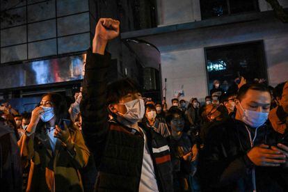 People sing slogans during a protest against China's zero-Covid policy in Shanghai on November 27, 2022.