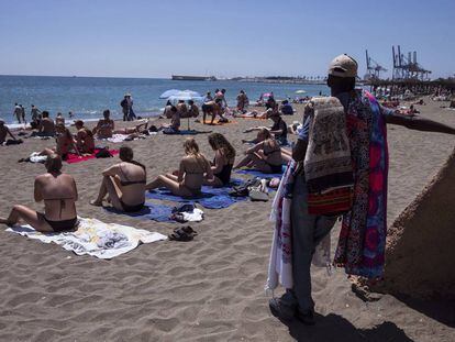Sunbathers on Malagueta beach in Málaga.
