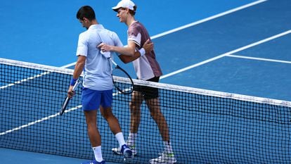 Italy's Jannik Sinner with Serbia's Novak Djokovic after winning his semi final match at Melbourne Park, Melbourne, Australia. January 26, 2024.