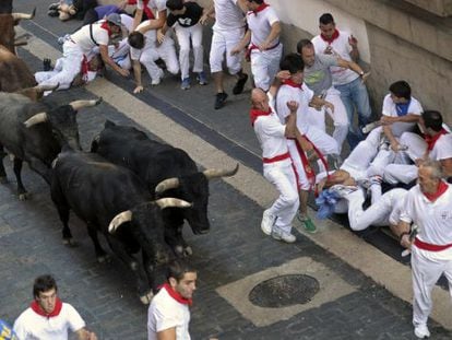 Runners do their best to avoid the bulls during the last day of Sanfermines on Sunday.