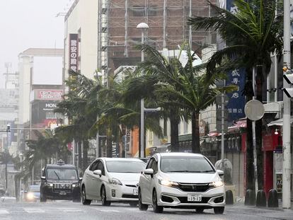 Vehicles drive through a street in a strong wind in Naha, Okinawa prefecture, southern Japan Sunday, Aug. 6, 2023