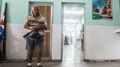 A patient waits with his X-Ray to see a doctor in the 18 October hospital in Havana.