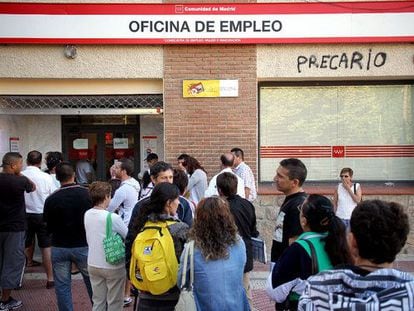People lining up in front of an unemployment office.