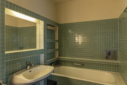 The bathroom remains exactly the same, only the shower curtain is missing.
