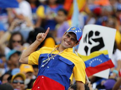 Opposition candidate Henrique Capriles encourages supporters on Sunday in Caracas.