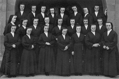 Orphanage head Sister Juana is wearing glasses, standing fifth to the right in the second row. Mercedes is resting her hand on the wall.