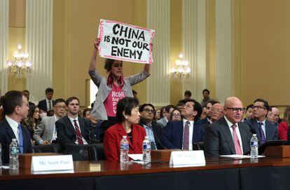 A protester disrupts the first hearing of the U.S. House Select Committee on Strategic Competition between the United States and the Chinese Communist Party as (L-R) Scott Paul, president of the Alliance for American Manufacturing, human rights activist Tong Yi, and Lt. Gen. H.R. McCaster (Ret.) testify, at the Cannon House Office Building on February 28, 2023 in Washington, DC.