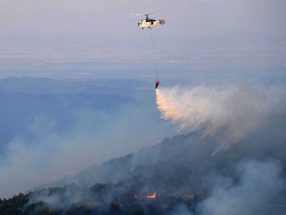 A firefighting helicopter drops water during efforts to put out wildfire in the area of Leptokarya, Evros, northern Greece, 26 August 2023 (issued 27 August 2023).