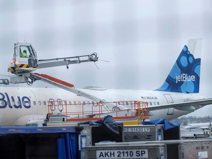 A Jet Blue aircraft is prepared for de-icing at Logan International Airport in Boston, Massachusetts, USA, 28 February 2023.