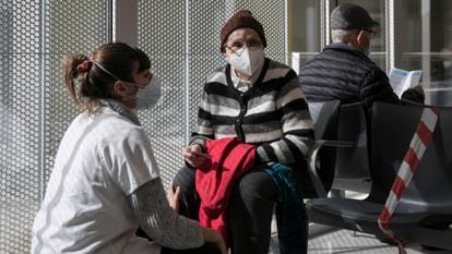 A woman waits to be vaccinated in Barcelona in February.