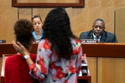 Djifa lee, a second-grade teacher at Saunders Elementary, center, stands with her daughter as she speaks in front of the Newport News School Board at the Newport News Public Schools Administration building on Tuesday.