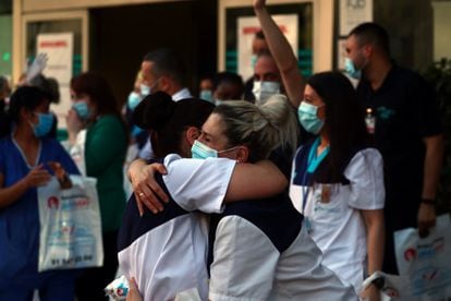 Medical staff from Fundacion Jimenez Diaz hospital embrace each other in Madrid on May 17.