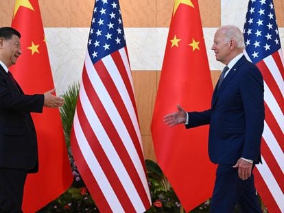 President Joe Biden and China's President Xi Jinping walk to shake hands as they meet on the sidelines of the G20 Summit in Nusa Dua on the Indonesian resort island of Bali on November 14, 2022.