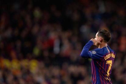 Coutinho plugs his ears and looks up at the Camp Nou terraces after scoring against United.