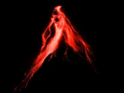 Mayon volcano belches red-hot emissions down it's slope as seen from Legaspi, Albay province, northeastern Philippines, 2023