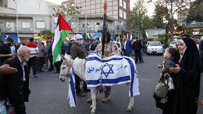 A donkey is dressed with Israeli flags during a celebration following Iran's attack on Israel, at the Palestine square, in Teheran, Iran, 15 April 2024.
