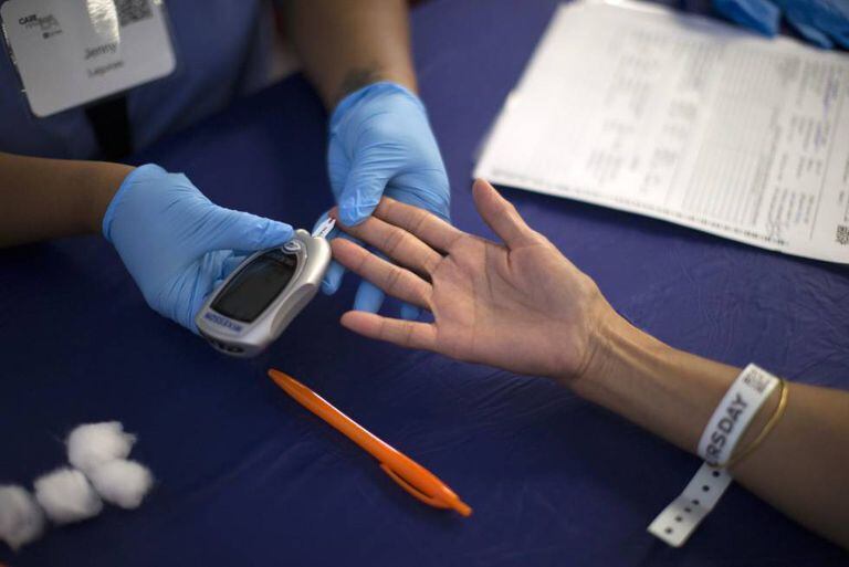 A diabetes test is administered. Up to one-third of people with diabetes can experience skin problems related to the disease.