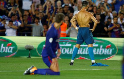 Who's the daddy? Piqué looks on at a shirtless Cristiano Ronaldo.