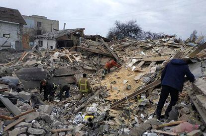 People searching among the rubble of residential buildings damaged by shelling in Ukraine's Zhytomyr region on Monday.