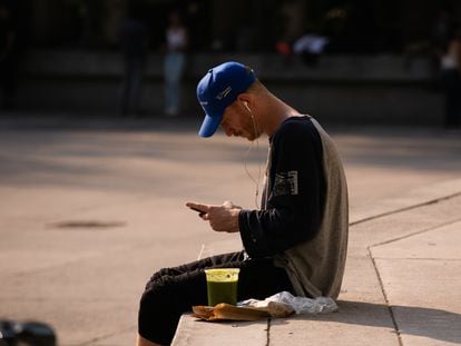 A young foreigner looks at his cell phone, in Mexico City.