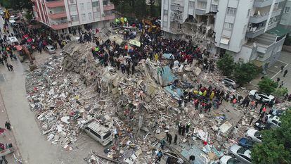 People search through rubble following an earthquake in Adana, Turkey.