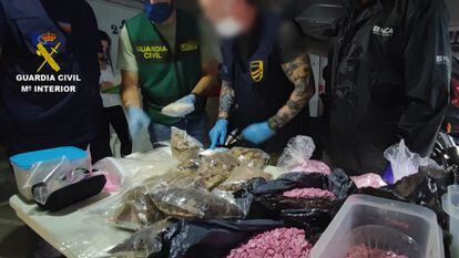 Spanish Civil Guard officers with packets of 'pink cocaine' and other drugs seized in Ibiza.