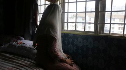Rohingya child bride, B, age 14, sits on a bed in an apartment in Kuala Lumpur, Malaysia, on Oct. 4, 2023. B came to Malaysia in 2023 to marry an older man.