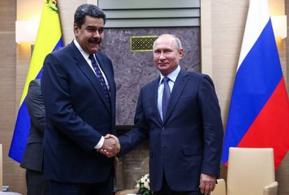 Venezuela's President Nicolas Maduro (l) and Russia's President Vladimir Putin (r) shake hands during a meeting at the Novo-Ogaryovo residence on December 5, 2018.