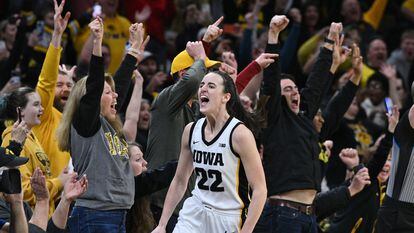 Iowa Hawkeyes guard Caitlin Clark celebrates setting the NCAA women's scoring record in a game against the Michigan Wolverines at Carver-Hawkeye Arena.