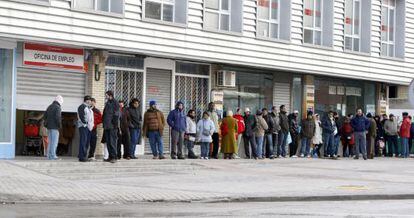 People line up outside an employment office.
