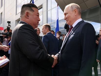 Russian President Vladimir Putin greets North Korean leader Kim Jong Un.