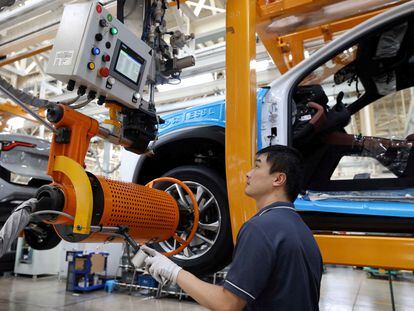 An employee works on the production line at an electric car factory in Hefei in August 2022.