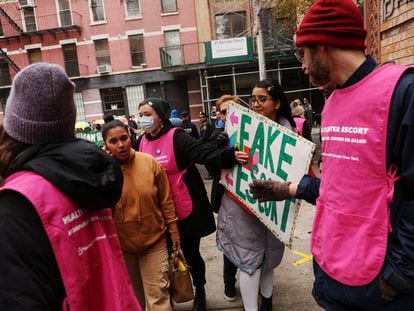 An anti-abortion activist attempts to block a woman from entering the Planned Parenthood Manhattan Health Center in New York City, U.S., December 2, 2023.