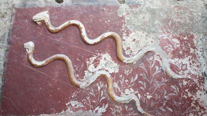 Two stucco snakes on the altar of the great Lararium found in Pompeii.