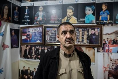 Mustafa Mina Nabi with photos of his son and other Kurdish-Iraqi migrants who drowned in the English Channel in 2021; Ranya (Iraqi Kurdistan); November 2022.