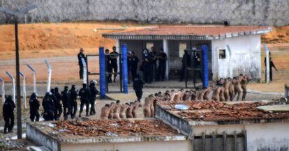 A group of prisoners being watched over by police after the mutiny.