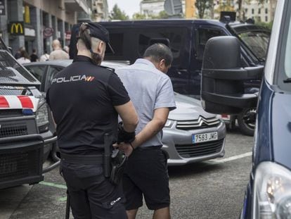 Officers from the Catalan and National Police force during a raid.
